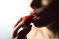 red lips eating strawberry. Hot desire. White background. N