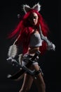 Sexy redhead woman in cosplay costume of warrior cat with swords