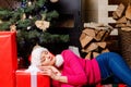 Sexy Santa woman posing on vintage wooden background. Portrait of beautiful girl wearing Santa clothes. Christmas Royalty Free Stock Photo