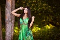 sensual very beautiful brunette girl in a green dress stand