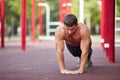 Shirtless muscular young man doing push-ups on the outdoors background. Exercise concept. Copy space. Royalty Free Stock Photo