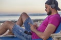 slim fit brunette man in blue jeans shorts and purple pink