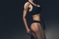 Sexy slim fit woman body. Muscled back. Sportswear. Dark background Royalty Free Stock Photo