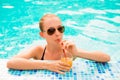 Sexy slim girl swimming in a pool with juice