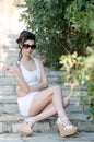 slim lady wear tight short white dress and sunglasses Royalty Free Stock Photo