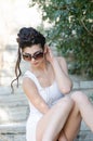 slim lady wear tight short white dress and sunglasses Royalty Free Stock Photo