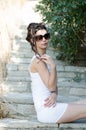 slim lady wear tight short white dress and sunglasses Royalty Free Stock Photo