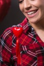 and smiling woman holding red heart Royalty Free Stock Photo