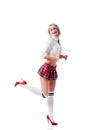 sexy smiling woman in short schoolgirl plaid skirt and knee socks with eyeglasses posing