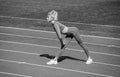 sexy sporty woman stretching and warming up in sportswear on stadium running track, health care Royalty Free Stock Photo