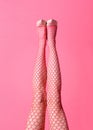 Sexy straight legs of a lady wearing pink fishnet stockings Royalty Free Stock Photo