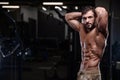 strong bodybuilder athletic men pumping up muscles with dum Royalty Free Stock Photo