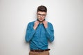 student wearing blue shirt and sunglasses fixes collar Royalty Free Stock Photo