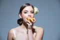 Sexy summer tropical fruit. Young beautiful model eating orange in studio. Summer mood. Dreaming italian or hispanic Royalty Free Stock Photo