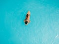 Surfer girl in bikini waiting wave on surfboard in blue ocean. Aerial view of woman during surfing Royalty Free Stock Photo