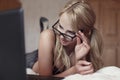 surprised blonde student reading message on laptop