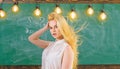 teacher concept. Woman with long hair in white blouse stands in classroom. Teacher with waving long blonde hair