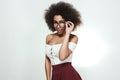 teacher. Studio portrait of young flirty afro american woman adjusting her eyewear and looking at camera while