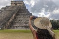 Sexy tourist girl with hat in front of the backdrop of the pyramid of Kukulcan in the Mexican city of Chichen Itza. Travel concept Royalty Free Stock Photo