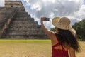 Sexy tourist girl with hat in front of the background of the pyramid of Kukulcan in the Mexican city of Chichen Itza. Royalty Free Stock Photo