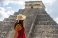 Sexy tourist under the sun rays of the pyramid of Chichen Itza in Mexico