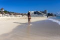 Sexy tourist woman walking on dolphin beach towards the hotel zone of Cancun Mexico enjoying the turquoise Caribbean Sea Royalty Free Stock Photo