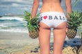 tropical woman close up with exotic pineapple fruit on the beach of paradise island of Bali. Healthy diet