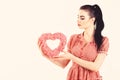 Valentine model Girl portrait. Gorgeous Valentines young brunette woman with heart shaped gift. Perfect make up Royalty Free Stock Photo