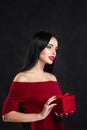 Valentine model Girl portrait. Gorgeous young brunette woman with red gift box. Perfect make up. Valentine` Day brunette lady Royalty Free Stock Photo