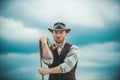 Sexy western man with cowboy hat. Cowboy with lasso rope on sky background. Royalty Free Stock Photo