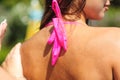 Sexy woman applying sunscreen to shoulder on the beach. UV protection and suntan. Skin care concept Royalty Free Stock Photo