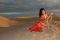 woman belly dancer arabian in desert dunes