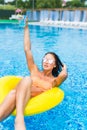 woman in bikini enjoying summer sun and tanning during holidays in pool with cocktail. Top view. Woman in swimming pool. Royalty Free Stock Photo