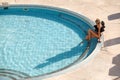 woman in bikini enjoying summer sun and tanning during vacation near the pool Royalty Free Stock Photo