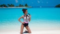 Sexy Woman in bikini on tropical beach. Pretty slim girl posing at exotic island by beautiful turquoise ocean. Fashionable Royalty Free Stock Photo