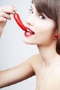 woman biting a chili pepper Royalty Free Stock Photo