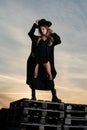 Sexy woman in black fashion coat, hat and black shoes boots. Fashion outdoor photo of gorgeous sensual woman in elegant Royalty Free Stock Photo