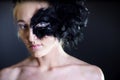 woman with black feather half mask Royalty Free Stock Photo