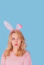 Sexy young Woman with Bunny Ears. Playboy Blonde. Looking up Easter Girl isolated on blue