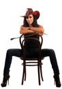 woman in cowboy hat sits on chair