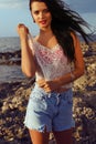 woman with dark hair posing on the beach Royalty Free Stock Photo