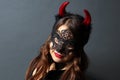 Sexy woman devil with carnival mask. Secret. Fashion. Venetian carnival. Party. Night background