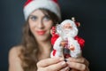 woman dressed in Santa Claus clothes gives you toy Royalty Free Stock Photo