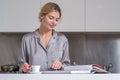 Sexy woman drink coffee and reading book or magazine at home in morning. Beautiful sensual female housewife have Royalty Free Stock Photo