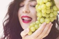 Sexy woman eating green grapes, sensual red lips Royalty Free Stock Photo