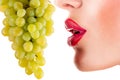 woman eating green grapes, sensual red lips Royalty Free Stock Photo