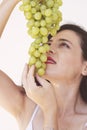 Sexy woman eating green grapes, sensual red lips Royalty Free Stock Photo