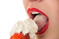 woman eating strawberry with cream, sensual red lips Royalty Free Stock Photo