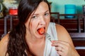 Woman Eating Strawberry. Sensual Red Lips. Red Manicure and Lipstick. Desire. Royalty Free Stock Photo