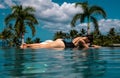 Sexy woman enjoying vacation holidays at luxurious beach in hotel resort with swimming pool and tropical lansdcape near Royalty Free Stock Photo